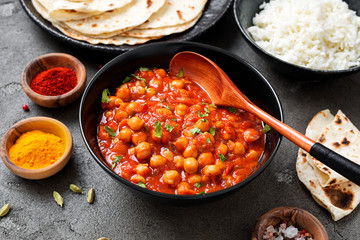 Traditional Indian dish chickpea chana masala with rice and flatbread.