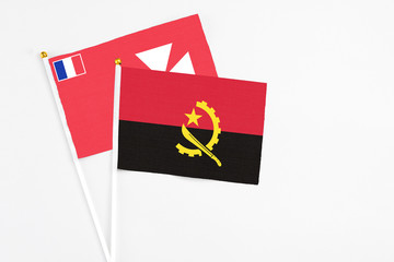 Angola and Wallis And Futuna stick flags on white background. High quality fabric, miniature...