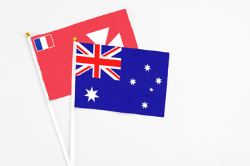 Fototapeta premium Australia and Wallis And Futuna stick flags on white background. High quality fabric, miniature national flag. Peaceful global concept.White floor for copy space.