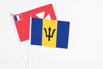 Barbados and Wallis And Futuna stick flags on white background. High quality fabric, miniature national flag. Peaceful global concept.White floor for copy space.