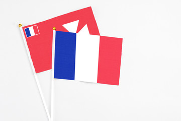 France and Wallis And Futuna stick flags on white background. High quality fabric, miniature national flag. Peaceful global concept.White floor for copy space.