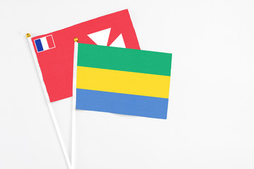 Gabon and Wallis And Futuna stick flags on white background. High quality fabric, miniature...