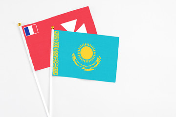 Kazakhstan and Wallis And Futuna stick flags on white background. High quality fabric, miniature national flag. Peaceful global concept.White floor for copy space.