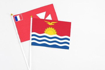 Kiribati and Wallis And Futuna stick flags on white background. High quality fabric, miniature national flag. Peaceful global concept.White floor for copy space.