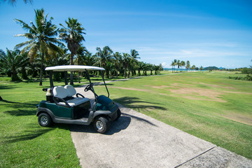 Golf carts on a golf course with blue sky