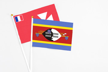 Swaziland and Wallis And Futuna stick flags on white background. High quality fabric, miniature national flag. Peaceful global concept.White floor for copy space.