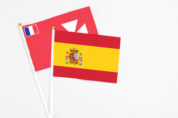 Fototapeta premium Spain and Wallis And Futuna stick flags on white background. High quality fabric, miniature national flag. Peaceful global concept.White floor for copy space.