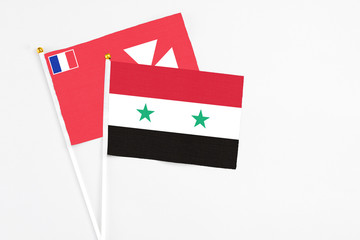 Syria and Wallis And Futuna stick flags on white background. High quality fabric, miniature national flag. Peaceful global concept.White floor for copy space.