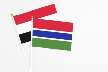 Gambia and Yemen stick flags on white background. High quality fabric, miniature national flag. Peaceful global concept.White floor for copy space.