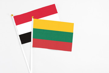 Lithuania and Yemen stick flags on white background. High quality fabric, miniature national flag. Peaceful global concept.White floor for copy space.