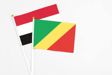 Republic Of The Congo and Yemen stick flags on white background. High quality fabric, miniature national flag. Peaceful global concept.White floor for copy space.