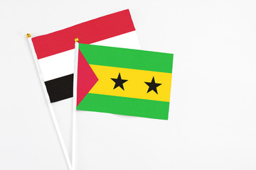 Sao Tome And Principe and Yemen stick flags on white background. High quality fabric, miniature national flag. Peaceful global concept.White floor for copy space.