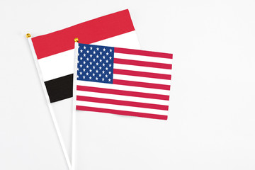United States and Yemen stick flags on white background. High quality fabric, miniature national flag. Peaceful global concept.White floor for copy space.