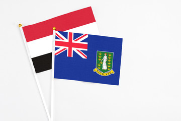 Fototapeta premium British Virgin Islands and Yemen stick flags on white background. High quality fabric, miniature national flag. Peaceful global concept.White floor for copy space.