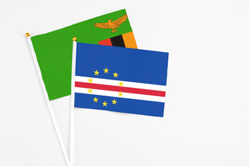 Cape Verde and Zambia stick flags on white background. High quality fabric, miniature national flag. Peaceful global concept.White floor for copy space.