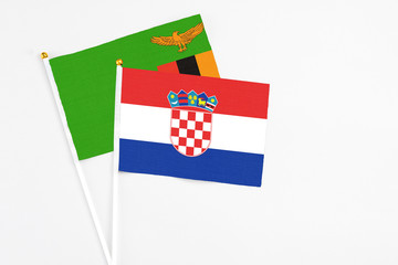 Croatia and Zambia stick flags on white background. High quality fabric, miniature national flag....