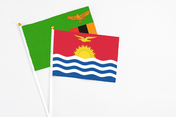 Kiribati and Zambia stick flags on white background. High quality fabric, miniature national flag. Peaceful global concept.White floor for copy space.