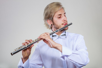 Male flutist playing his flute © anetlanda