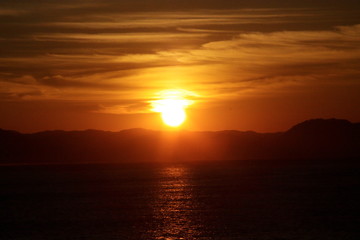 The morning sun climbing from the sea of clouds