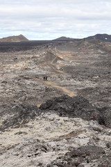 Hikers on lava