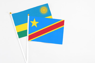 Congo and Rwanda stick flags on white background. High quality fabric, miniature national flag. Peaceful global concept.White floor for copy space.