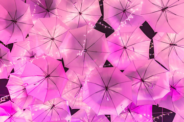 A lot umbrellas which decorated with lighting lamp and open lighting in night time for festival.