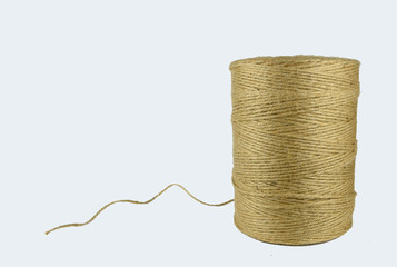 Spool of thread of natural jute thread on white background