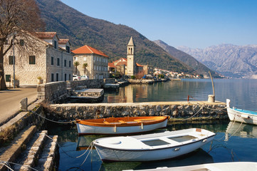 Small Mediterranean village against mountains. Montenegro, Adriatic Sea. View of Bay of Kotor and...