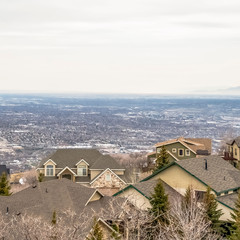 Square Aerial view of houses in the valley with mountain and horizon in the distance