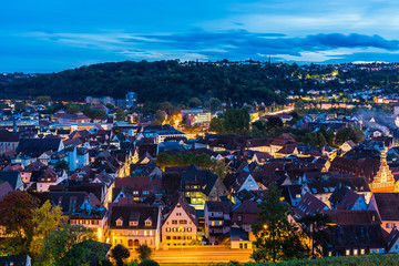 Naklejka premium Germany, Twilight and magical lights of skyline of medieval village esslingen am neckar, aerial view above roofs, houses and street by night