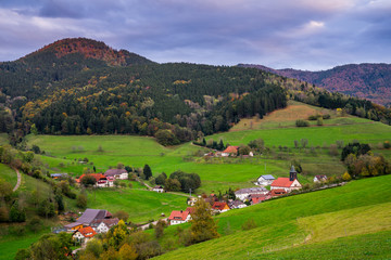 Fototapeta na wymiar Germany, Black forest village elzach yach houses and church in idyllic valley surrounded by colorful nature landscape of german vacation region in autumn season