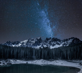 Milky way over Carezza lake at night, Dolomites, Italy