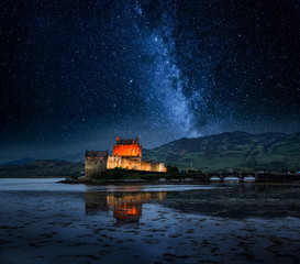 Illuminated Eilean Donan Castle at night in Scotland - Powered by Adobe