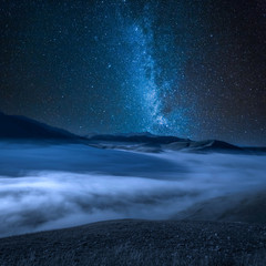 Milky way over foggy valley near Castelluccio, Italy - obrazy, fototapety, plakaty