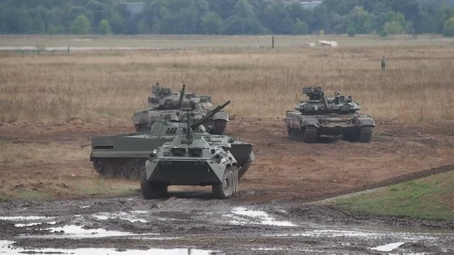 Russhian heavy armored vehicles maneuvering on polygon