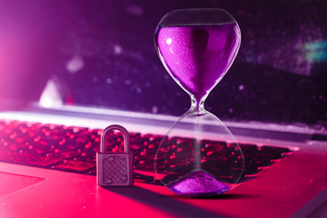 security lock on a computer keyboard - computer security concept Hourglass on laptop computer...