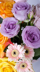 Various flowers bouquet. Pink Gerberas and gentle lilac roses close up.