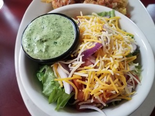 salad with lettuce and cheese and green sauce