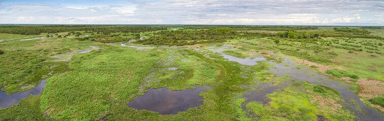 Aerial panorama of typical Pantanal Wetlands landscape with lagoons, forests, meadows, river, Mato Grosso, Brazil