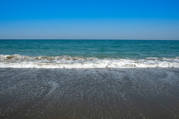 Fototapeta na wymiar Golden sand blue Sea and clear blue sky