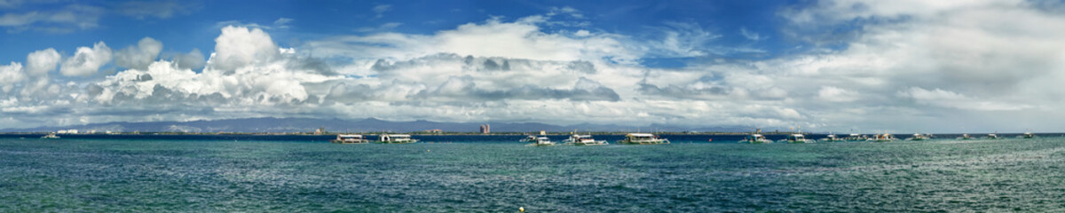 Fototapeta na wymiar Panoramic seascape wit boats on the horizon