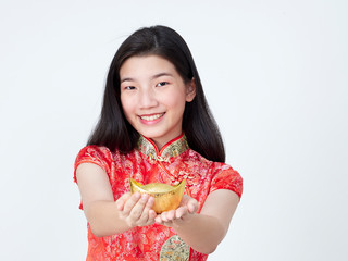 Young woman in traditional chinese dress showing chinese gold