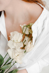 Fototapeta premium girl in white shirt with flower in hand