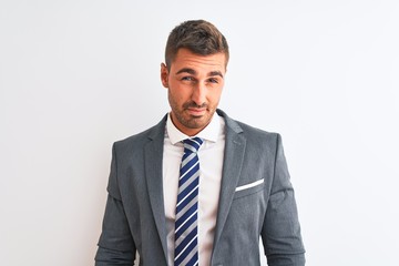 Young handsome business man wearing suit and tie over isolated background looking sleepy and tired, exhausted for fatigue and hangover, lazy eyes in the morning.