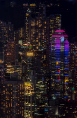 Fototapeta na wymiar Hong Kong city lights, highlighting The Center building (at right); Dense, abstract view serves as a dark, colorful backdrop.