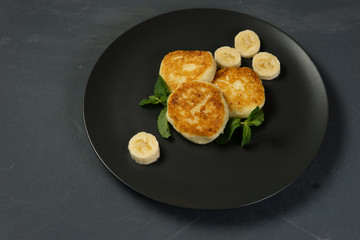 Cottage cheese pancakes on a dark plate