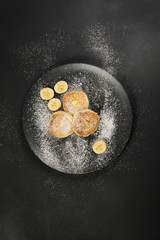 Cottage cheese pancakes on a dark plate