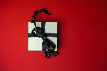 Gift box on red background. Top view 