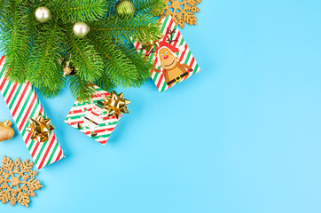Christmas background with fir branches, various christmas decorations, colored garlands and beads, on a blue background. Christmas decoration. Christmas background. Space for text.