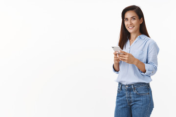 Successful good-looking lifestyle coach launch new online program, contact customers via smartphone text message, use app order taxi, smiling camera carefree, stand casual pose white background